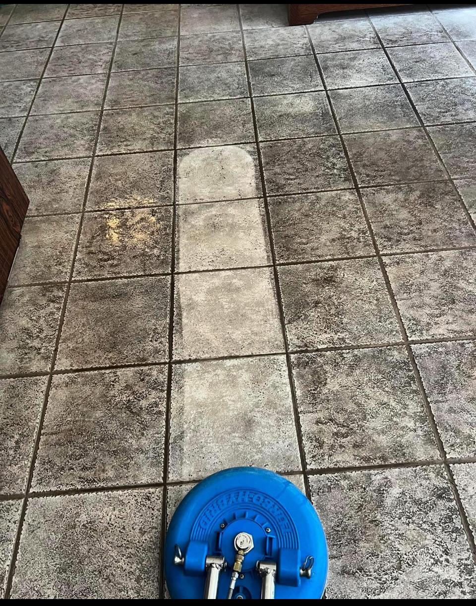 A friendly professional carpet cleaner using equipment.